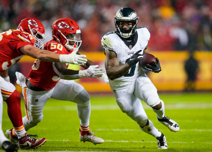 Philadelphia Eagles running back D'Andre Swift (0) runs the ball against Kansas City Chiefs linebacker Willie Gay (50) and defensive end George Karlaftis (56) during the first half at GEHA Field at Arrowhead.